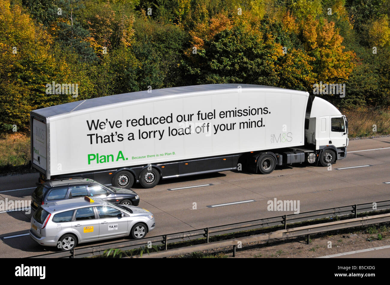 M25 motorway' Marks and Spencer lorry with fuel emission and plan A slogan cars overtaking Stock Photo