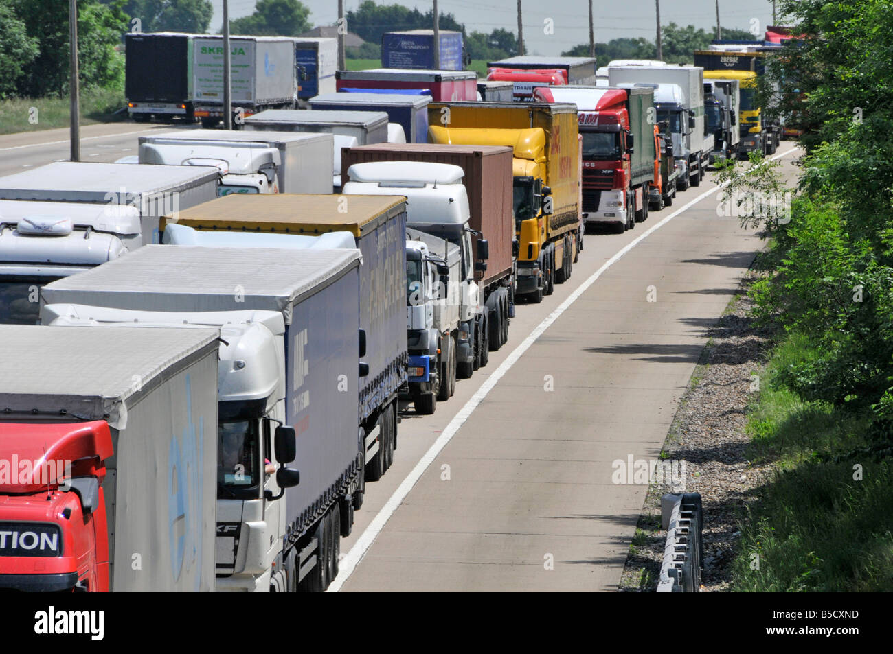 M25 motorway long queue of trucks gridlocked in traffic jam Stock Photo