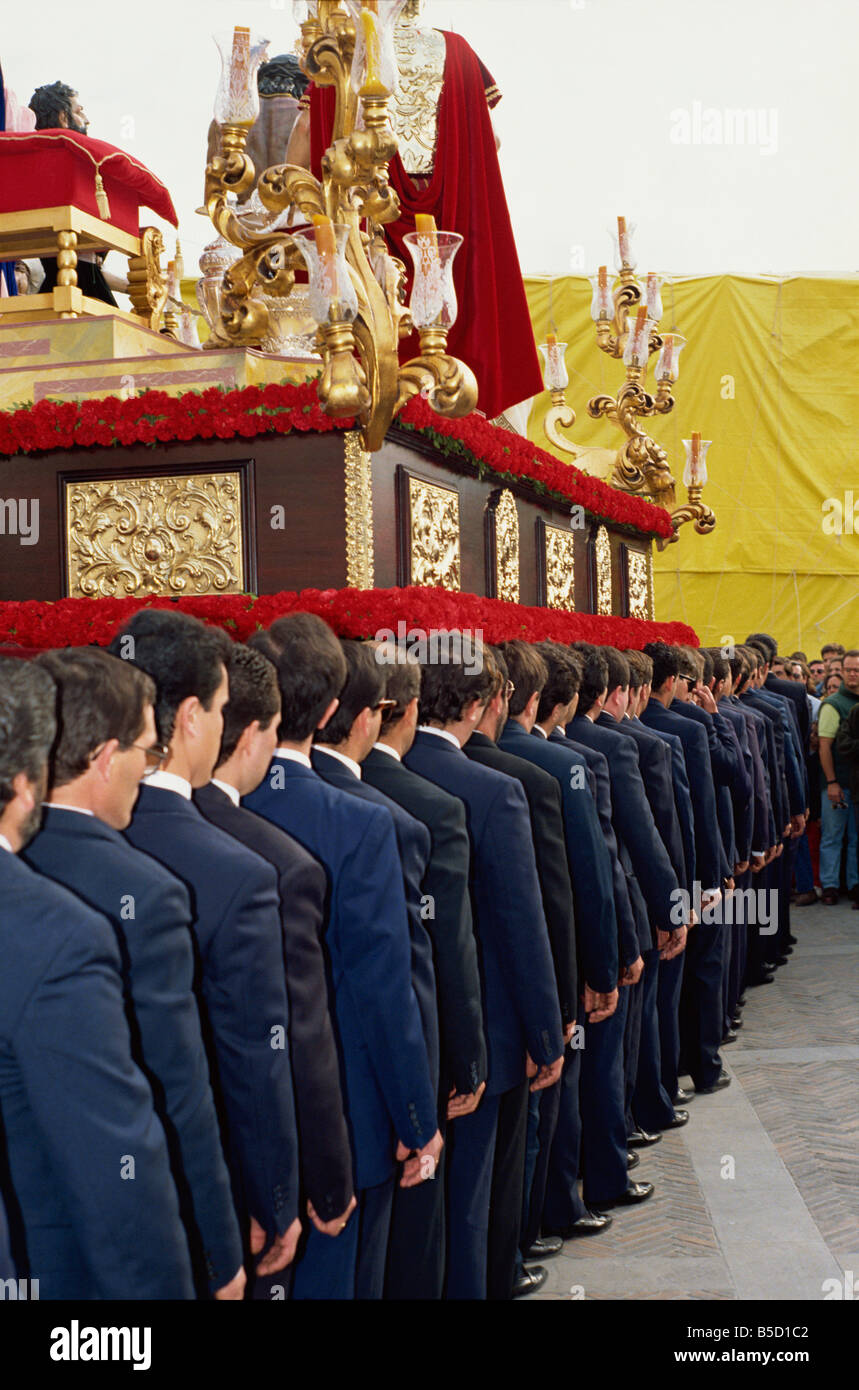 Line of men from La Salud Brotherhood on Palm Sunday Easter week in Malaga Andalucia Spain Stock Photo