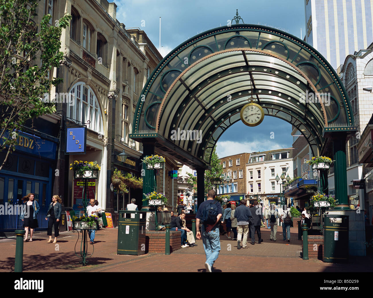Entrance to shopping arcade with clock on a pedestrianised street off