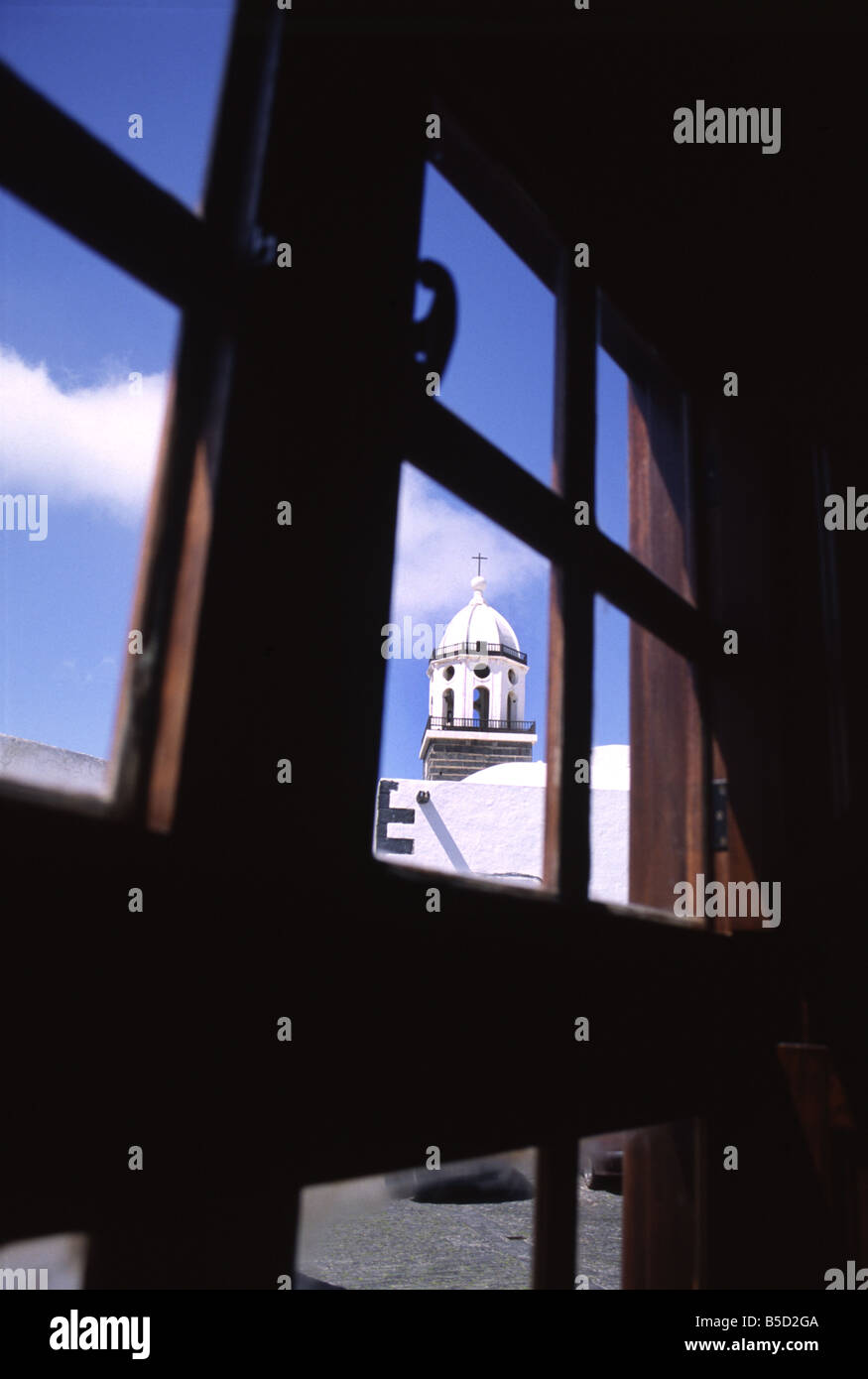 White church steeple through a wooden window pane. Stock Photo