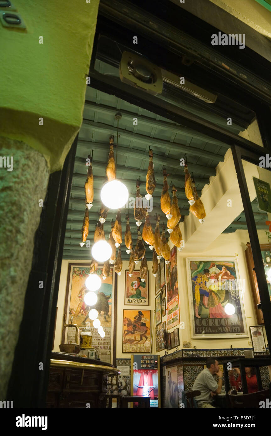 Tapas bar and restaurant with hams hanging from the ceiling, Santa Cruz district, Seville, Andalusia, Spain, Europe Stock Photo