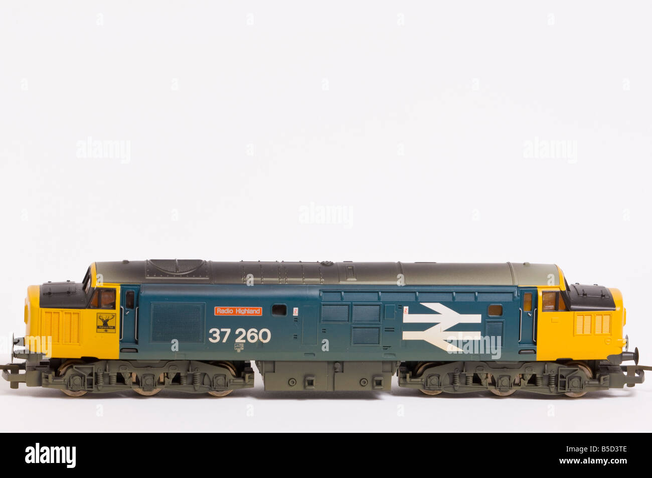 Close up of a  Hornby electric class 37 diesel model train in blue and yellow livery shot against a white background (cut out) Stock Photo