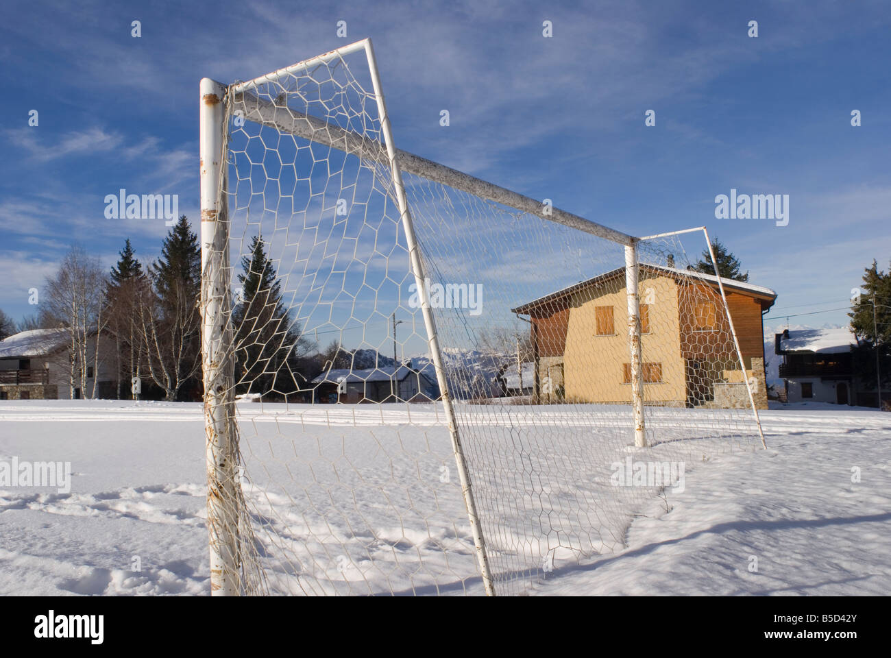 snow covered football playing field in a small village on the Italian Alps Italy Stock Photo