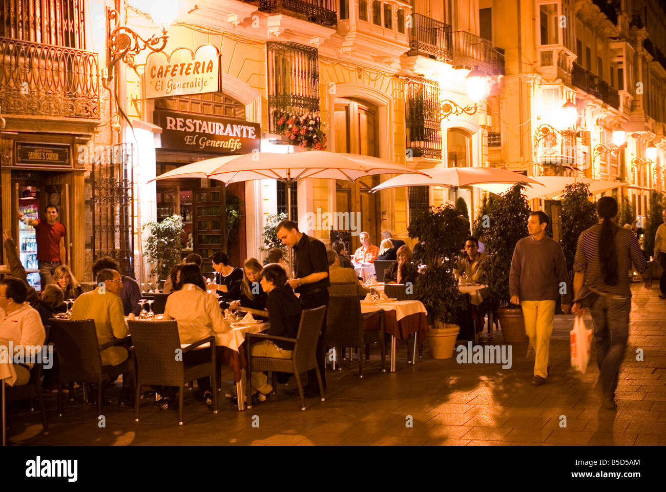 People sitting outside cafe restaurant El Generalife on Calle Caballeros in the historic El Carmen city centre of Valencia Spain Stock Photo