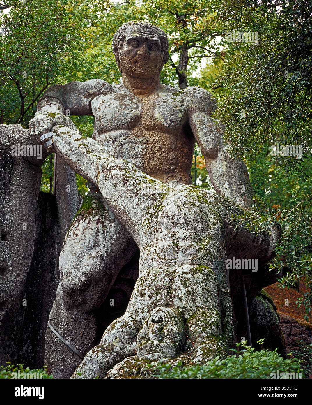 hugh violent statue of fighting giants in Sacro bosco - Bomarzo Monsterpark  of Vicino Orsini Gigantenkampf Stock Photo