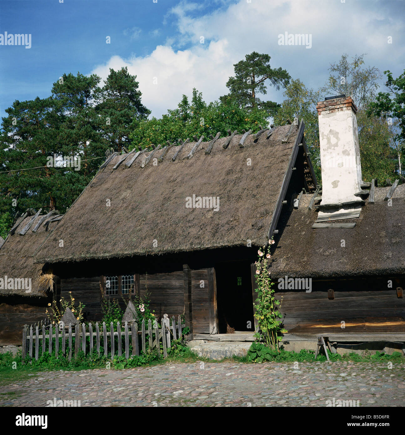 C18th wooden building with thatched roof of the Oktorp farmstead from Halland in the Skansen Open Air Museum in Stockholm Sweden Stock Photo
