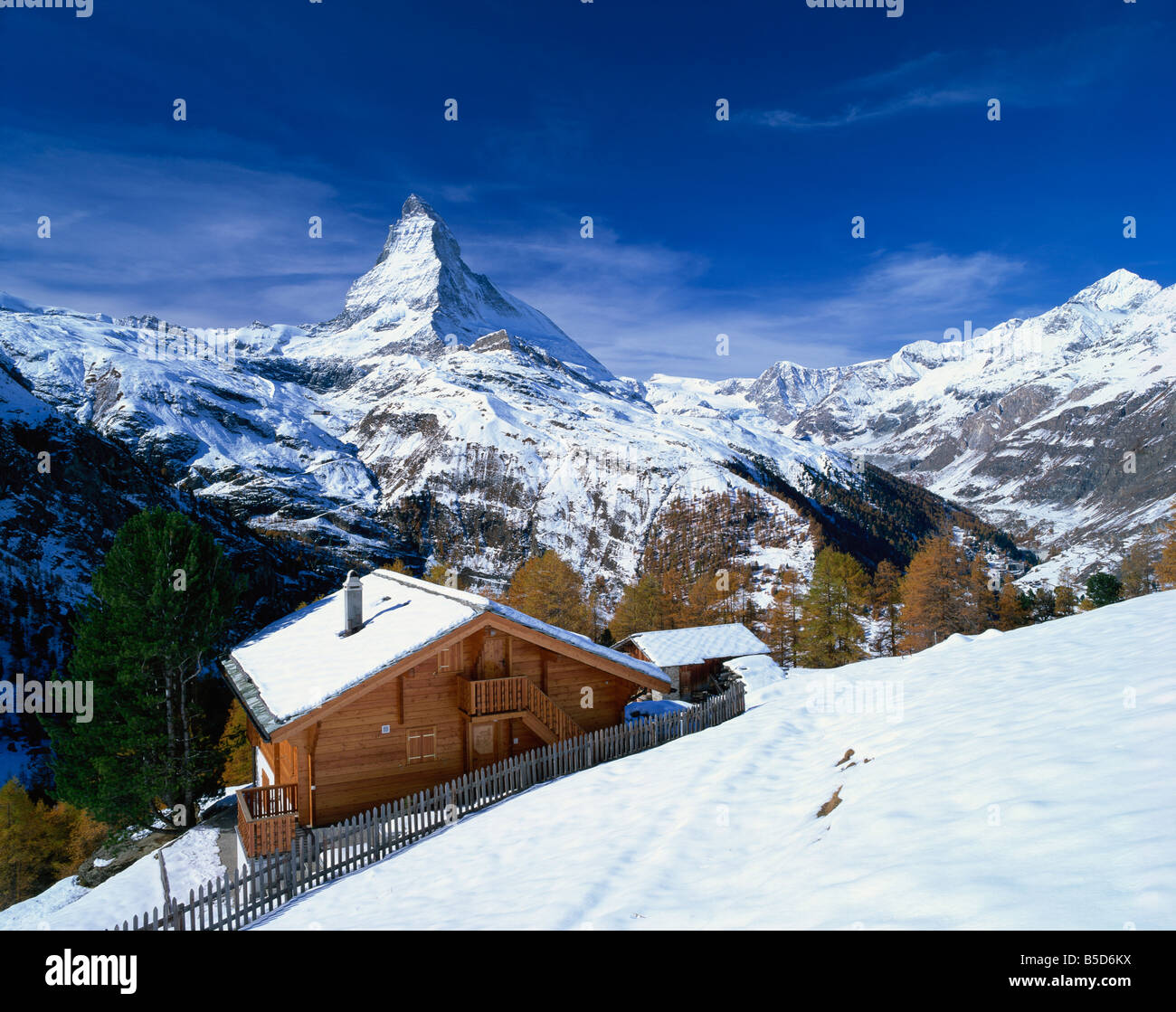 Chalets in a snowy landscape with the Matterhorn peak near Zermatt ...