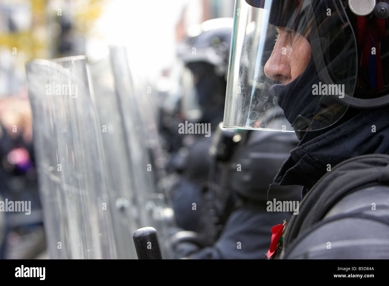 close up of line of PSNI Police Service of Northern Ireland riot officers form a protective barrier with riot shields during dis Stock Photo