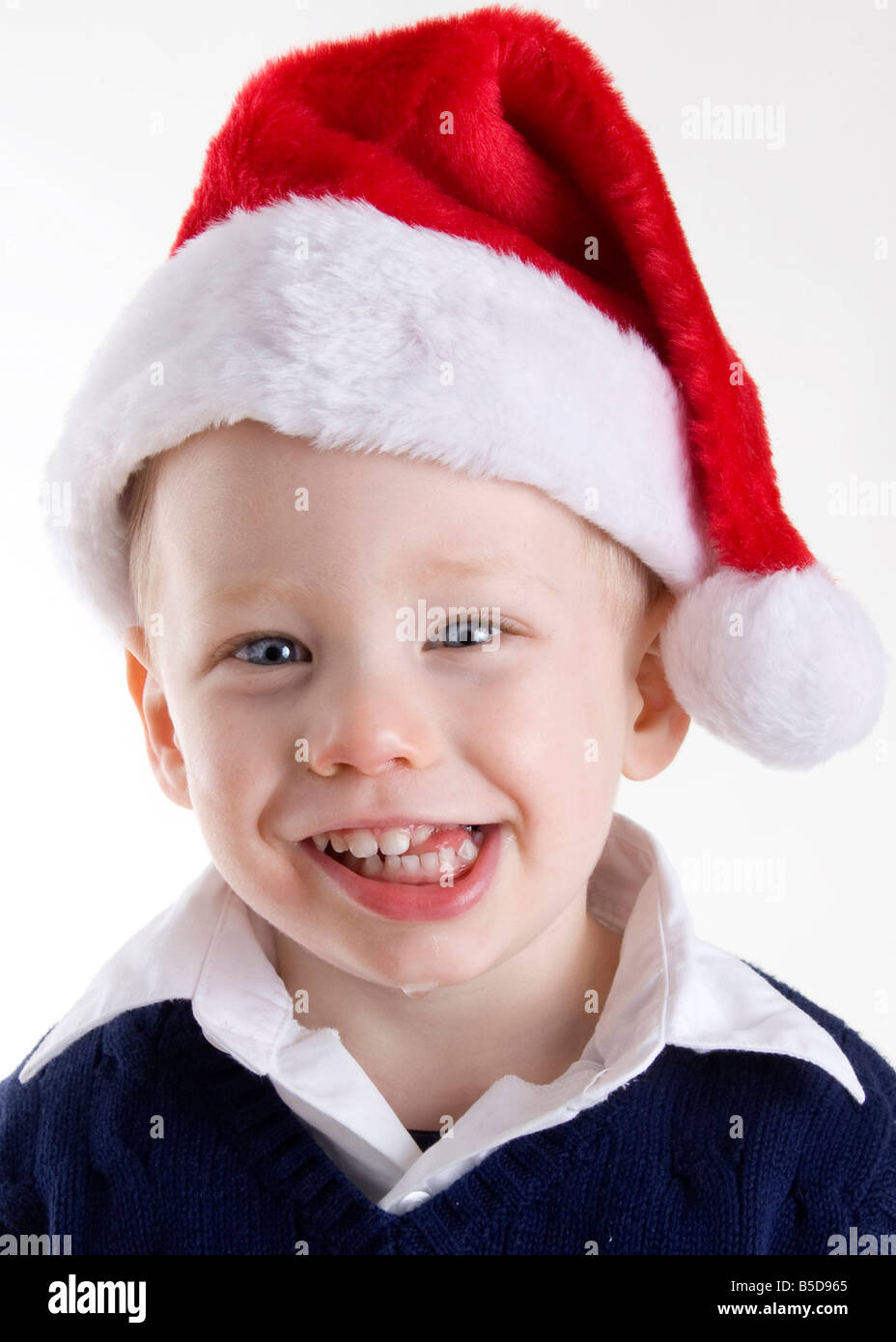 Handsome young child wearing a red santa claus hat Stock Photo - Alamy