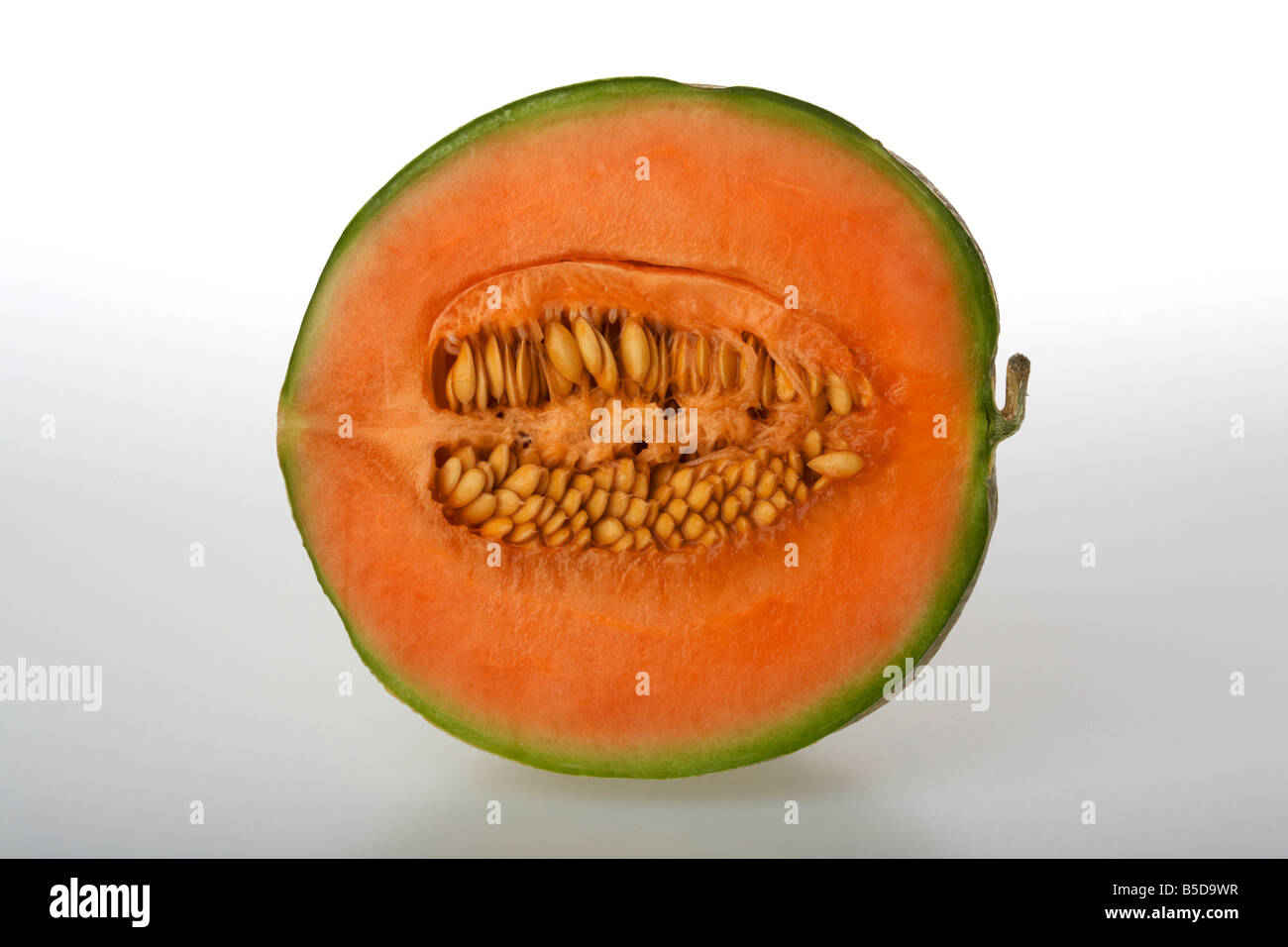cut half of ripe european cantaloupe melon showing seeds Stock Photo
