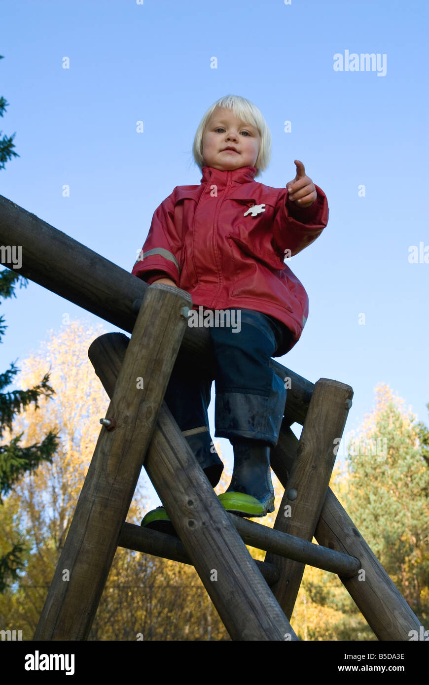 young girl climbing a ladder Stock Photo Alamy