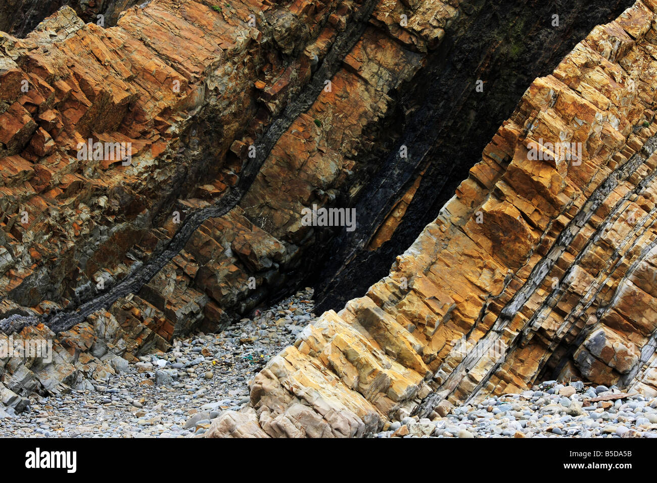 A small sea cave with interesting rock formations Stock Photo - Alamy