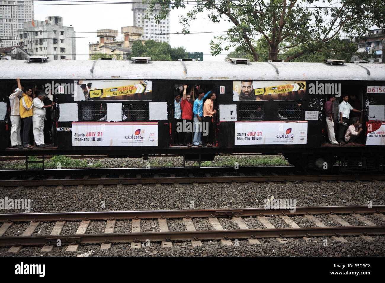 Passengers riding a local train, Mumbai, India Stock Photo Alamy