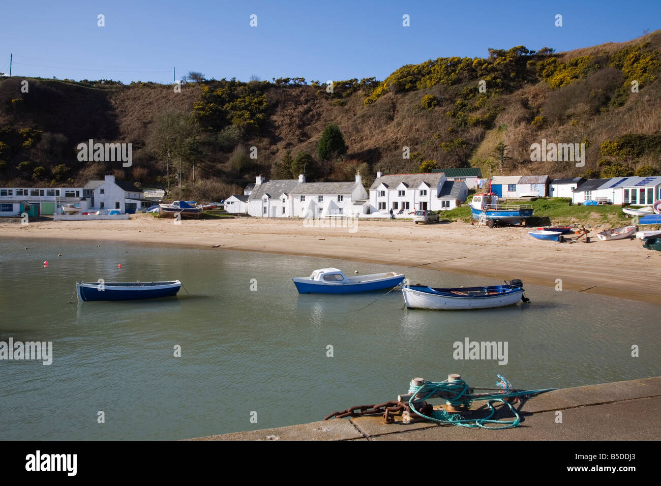 White cottages, beach and boats from jetty at Penrhyn Nefyn, Morfa