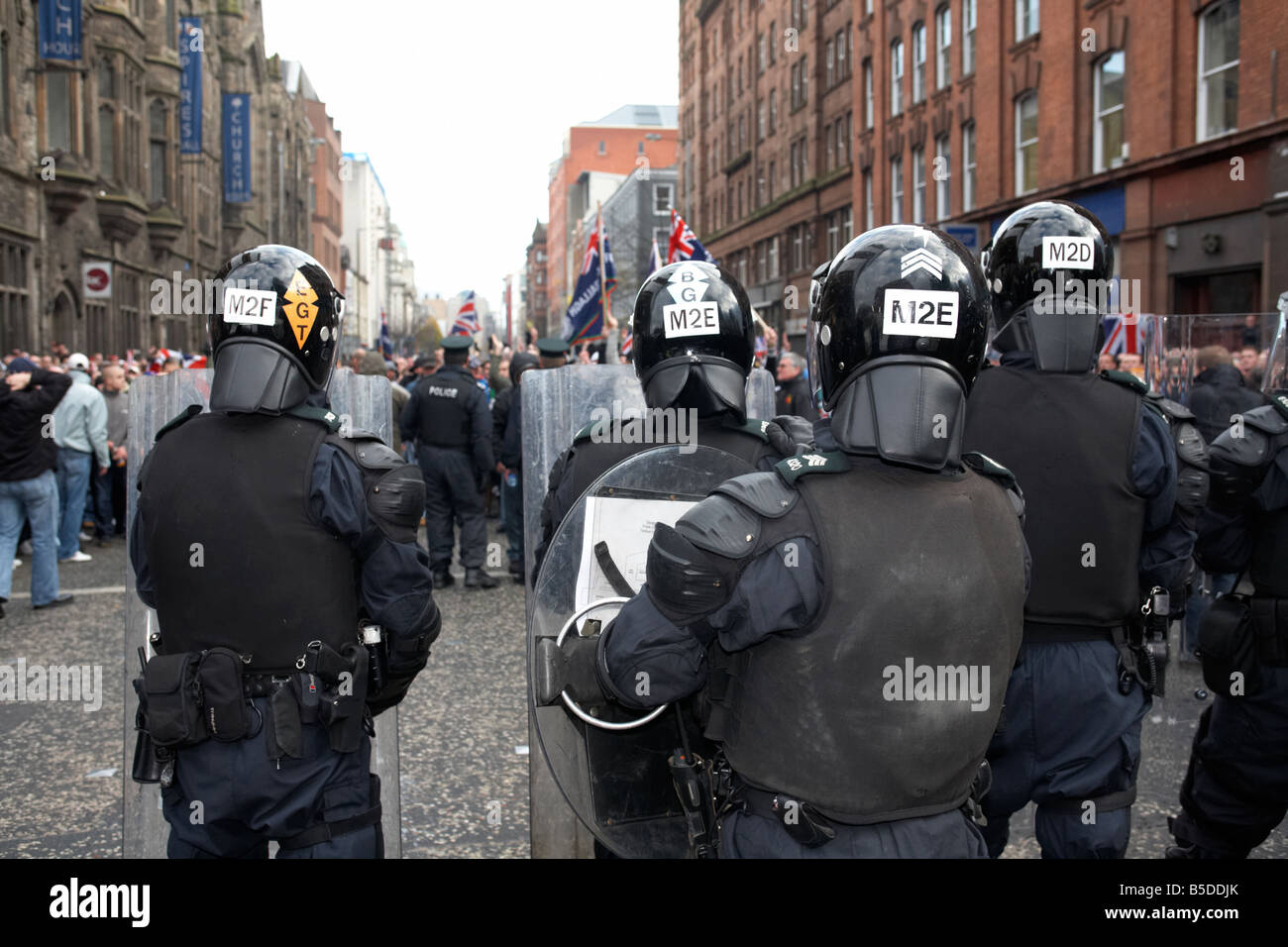 PSNI Police Service of Northern Ireland riot control officers standing guarding during loyalist protest parade belfast city centre northern ireland Stock Photo