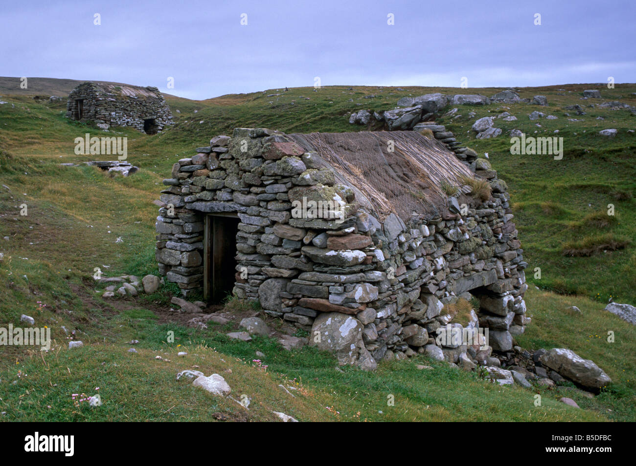 A restored old click mill alongside a small burn, grind grain in earlier times, Huxter, Shetland Islands, Scotland Stock Photo