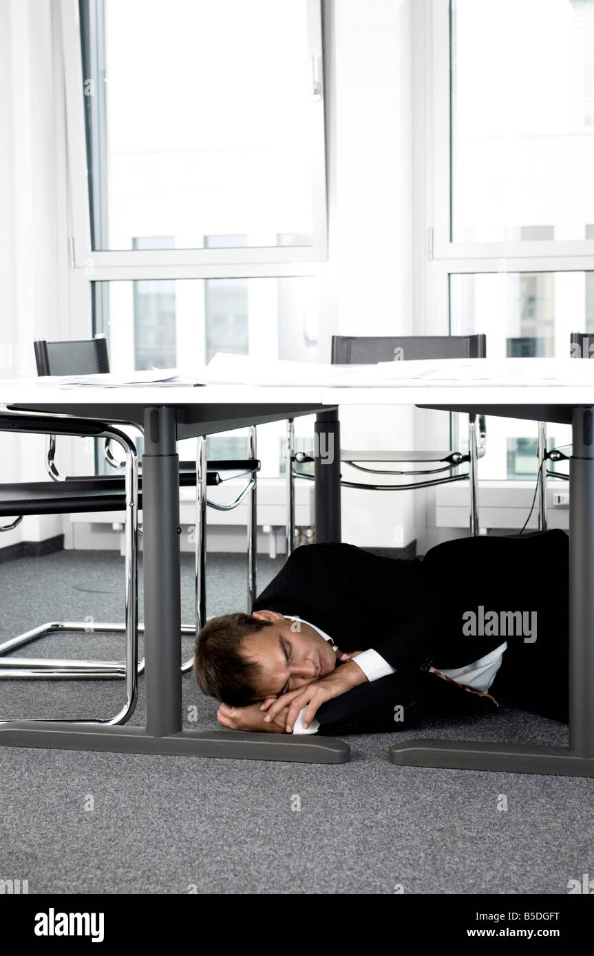 Businessman Sleeping Under Desk Stock Photo 20582012 Alamy