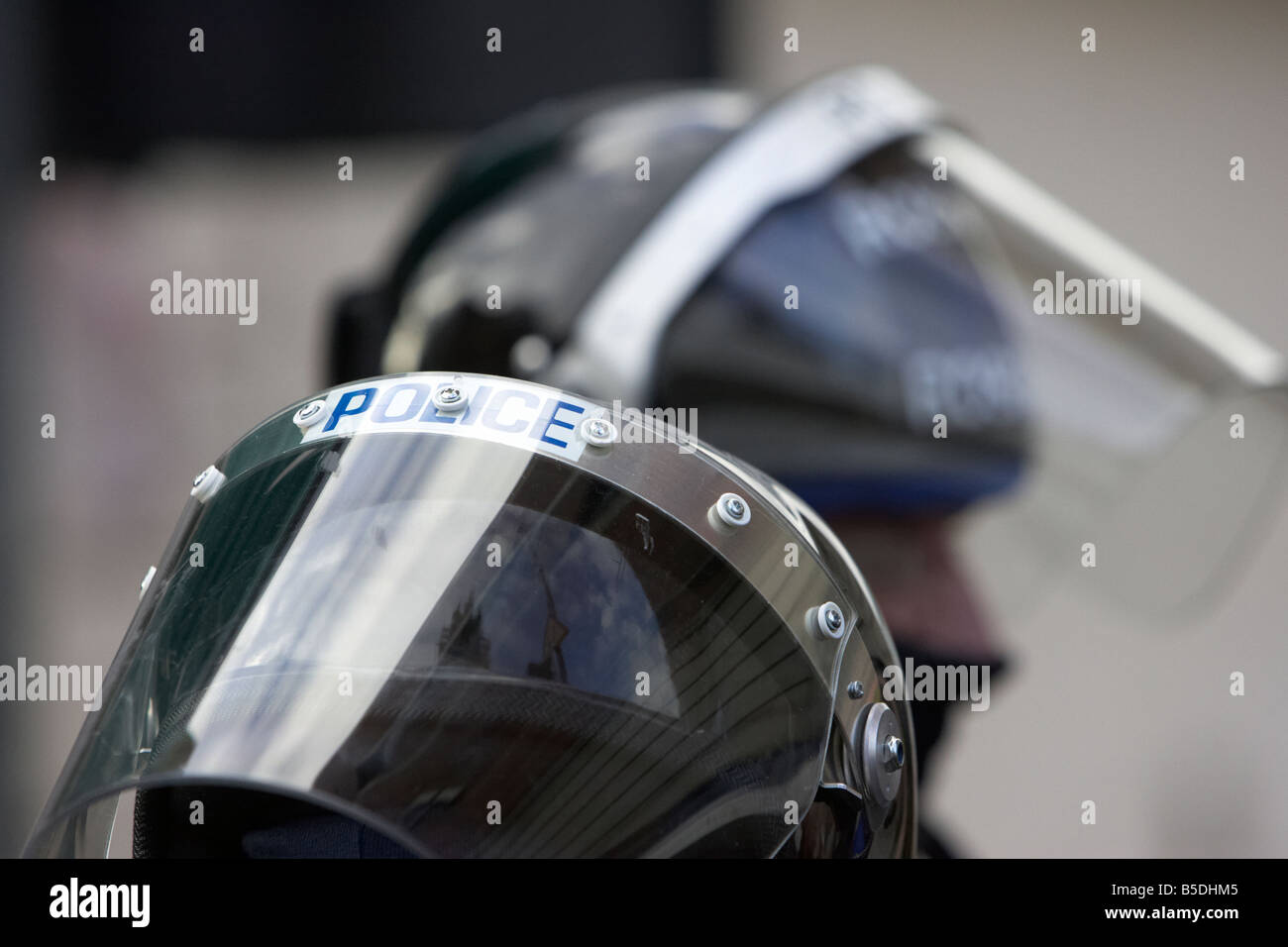 two PSNI Police Service of Northern Ireland riot control officers wearing protective helmets and visors Stock Photo