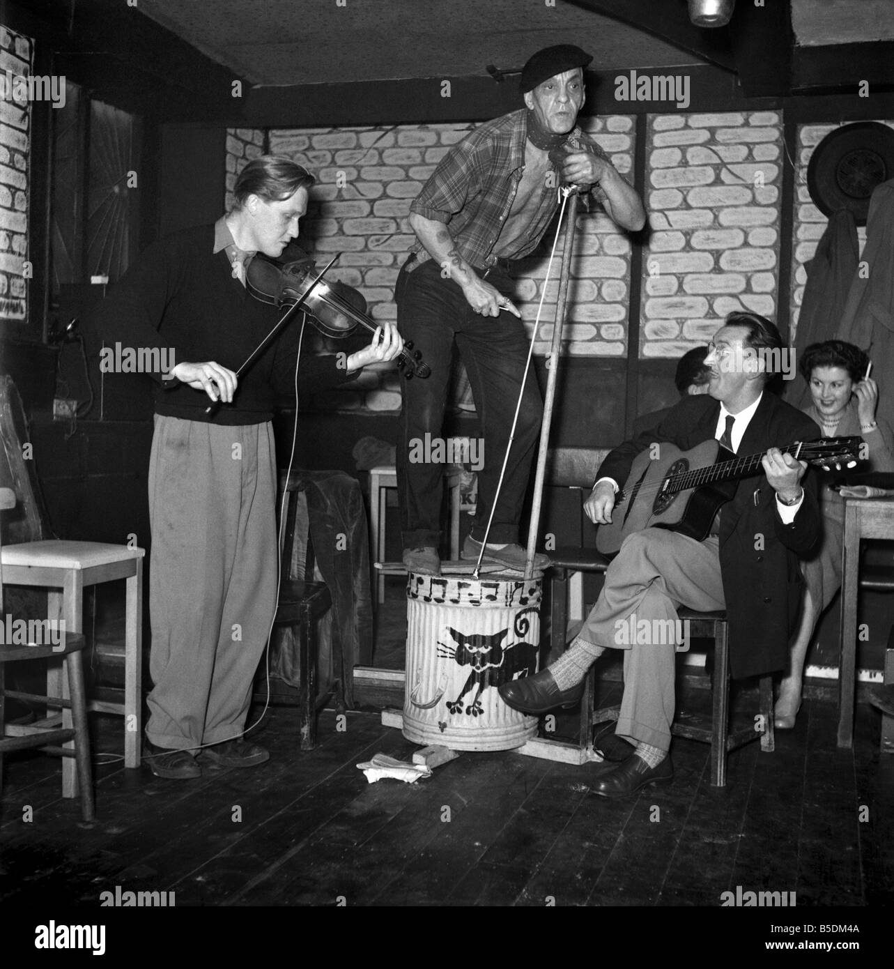 Skiffle group belived to be called the Black Cat seen here performing in a pub. The bass is created by using a dustbin and a broom. 1954 Circa 1954 Stock Photo