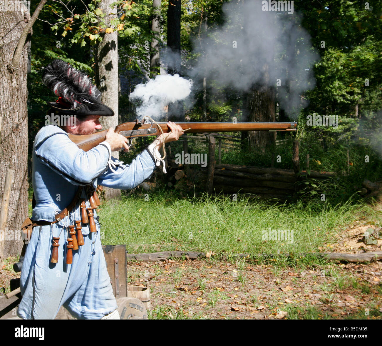 A historical re-enactor fires a 17th century musket at Henricus Virginia Stock Photo