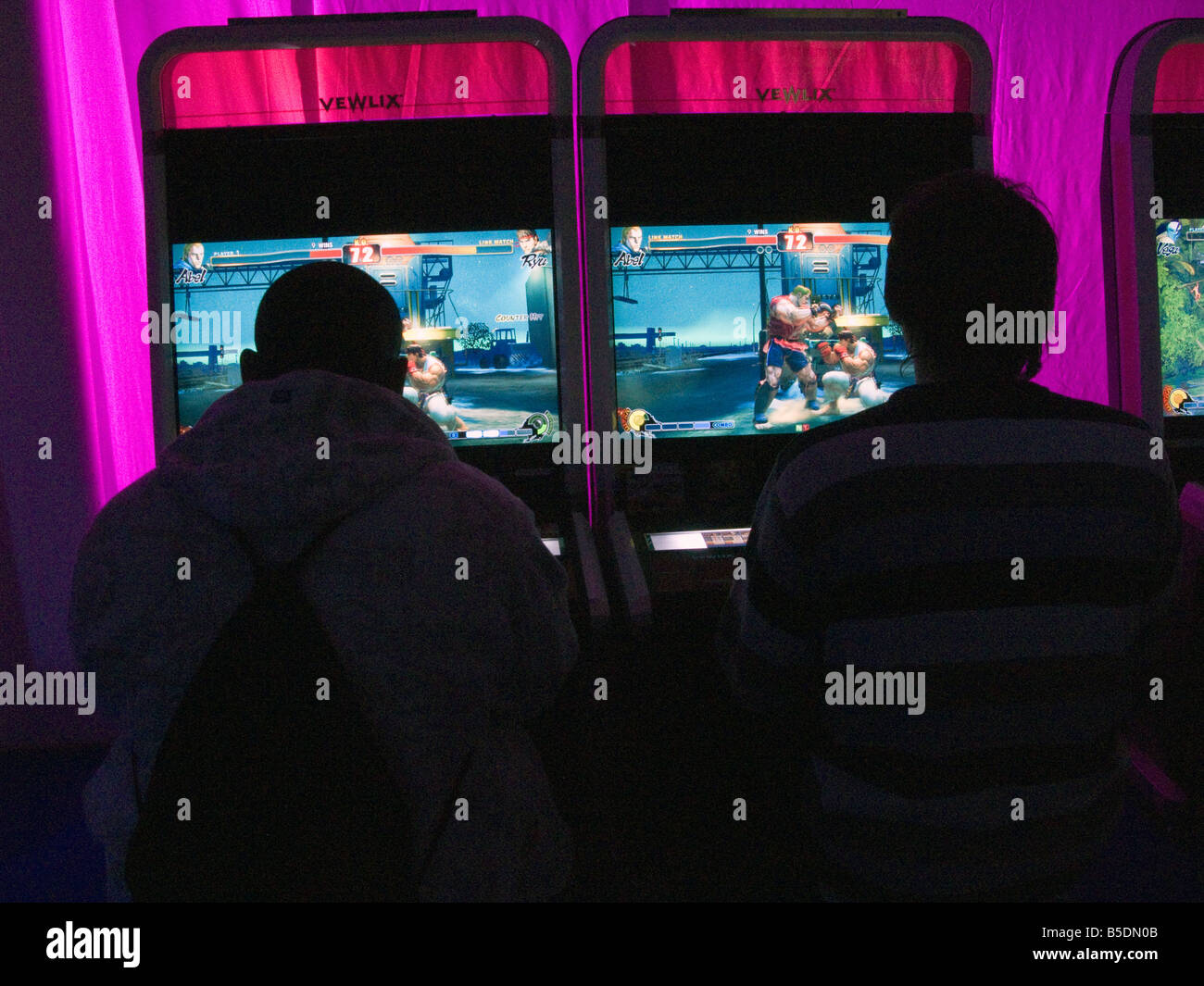 UK.Young people playing the latest games in amusement arcade,London.Photo © Julio Etchart Stock Photo