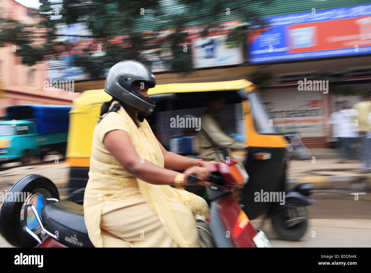 Woman on a scooter in traffic, in Bangalore, India Stock Photo Alamy