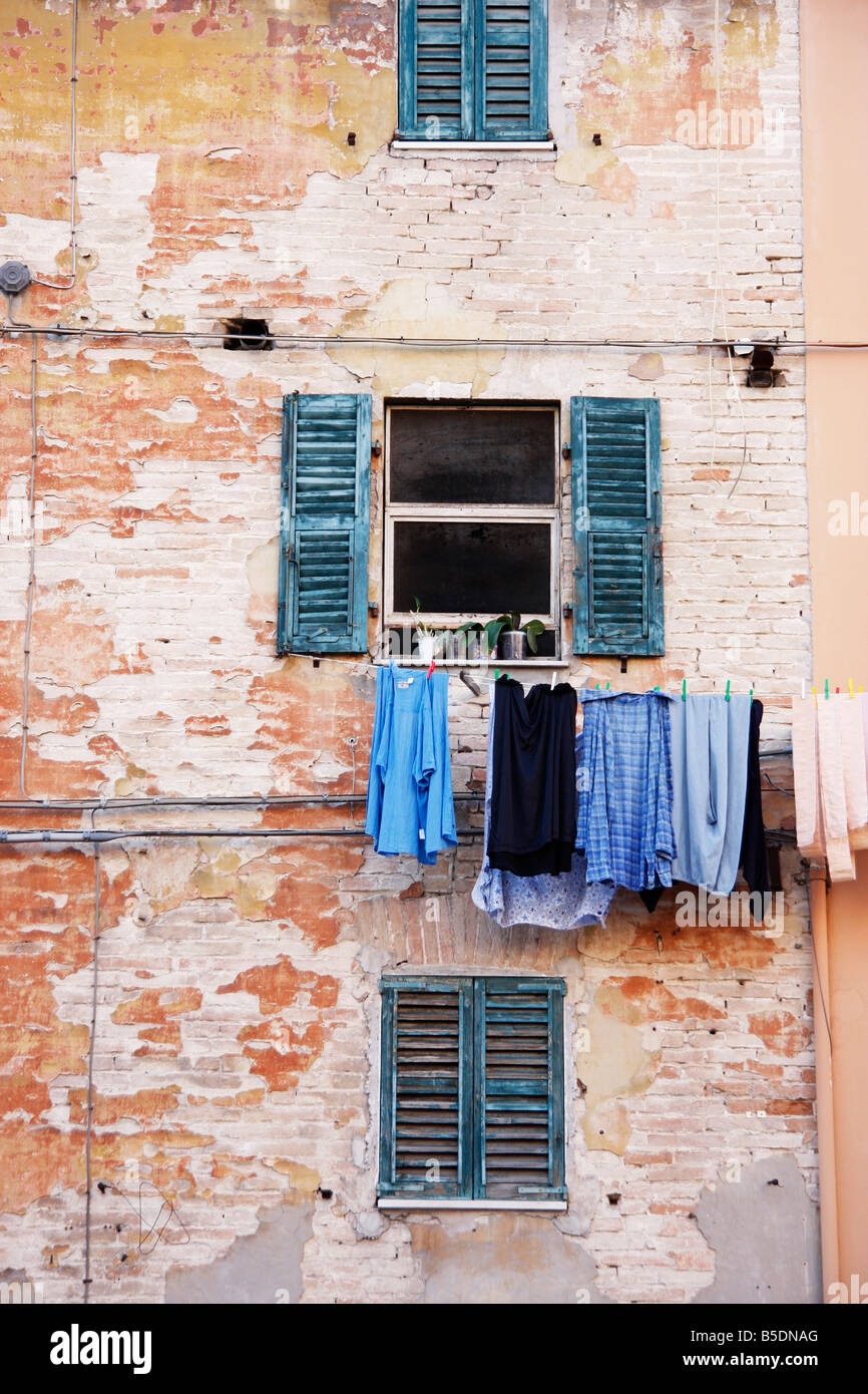 washing hangs from a colorful house in the historic Italian hilltown of Jesi Stock Photo