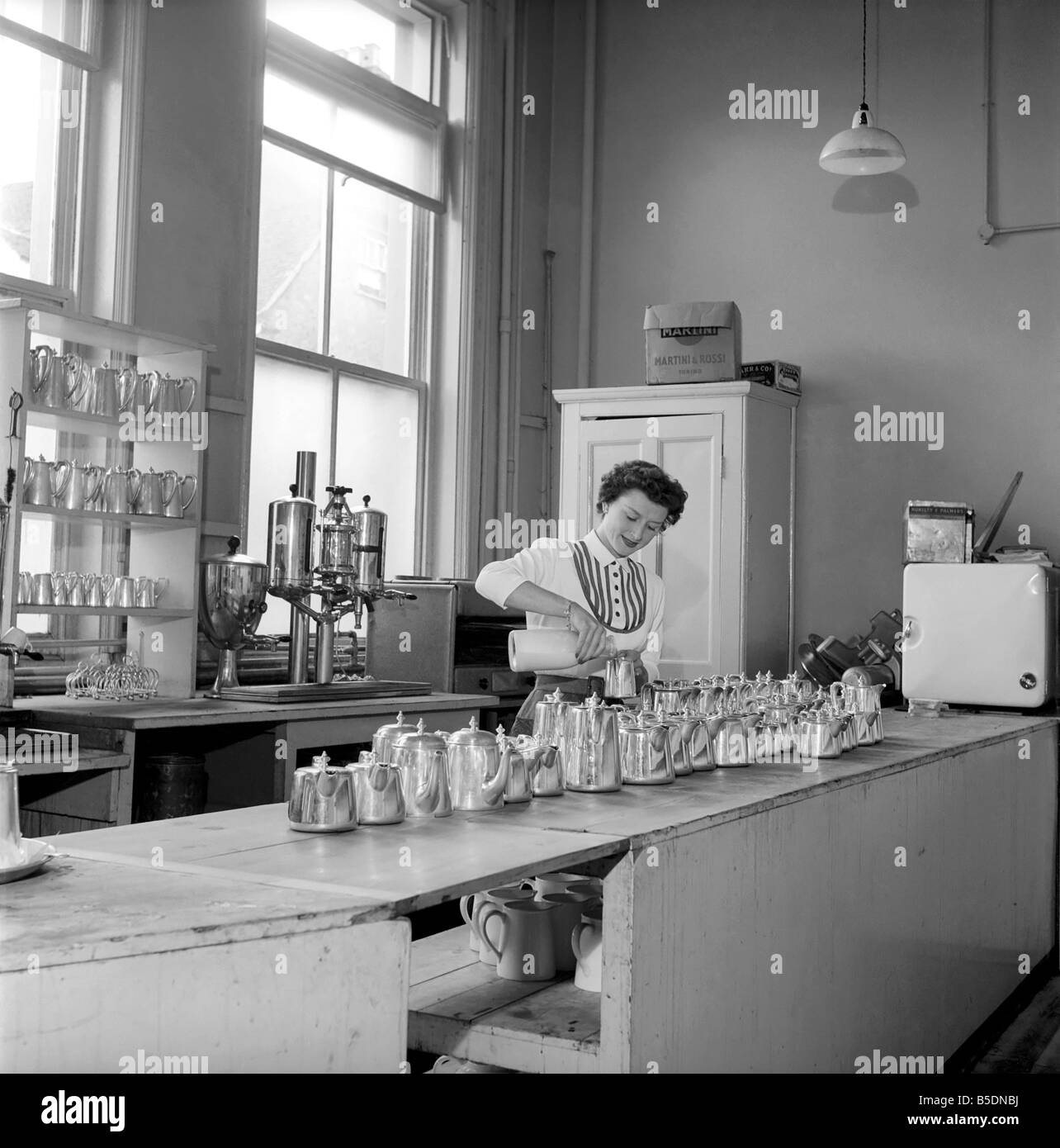 Waitress/woman seen here preparing pots of tea in a cafe. 1957 A17b-001 Stock Photo