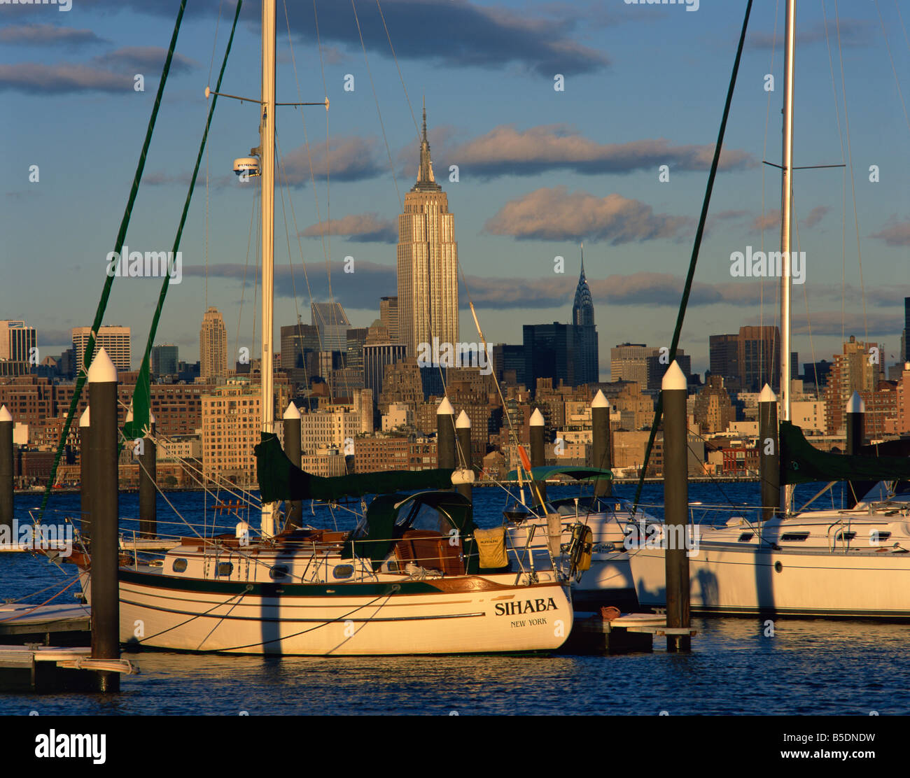 Boats in the harbour with the Empire State Building on the skyline in the background, in New York, USA Stock Photo