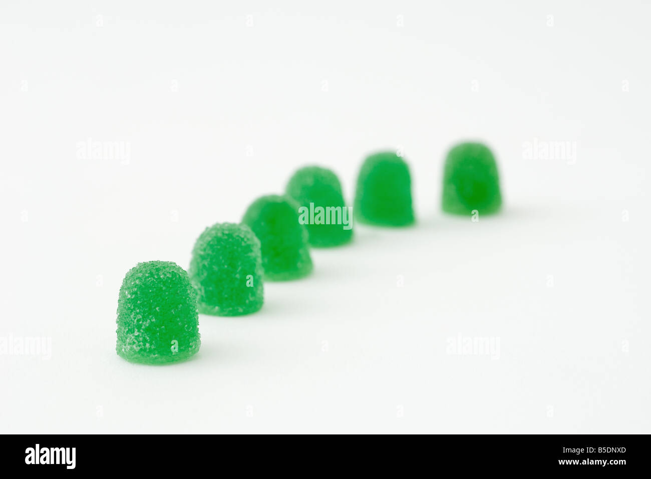 Green gum drops in a line Stock Photo - Alamy