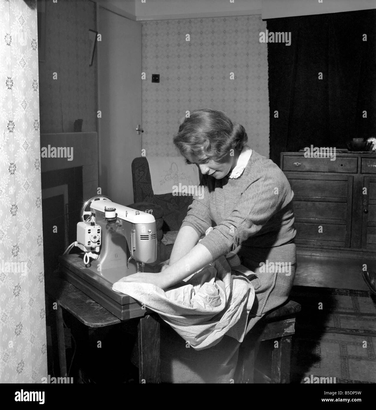 Woman at sewing machine: Mrs. John Theakeston seen here making a dress. April 1959 A775a-002 Stock Photo