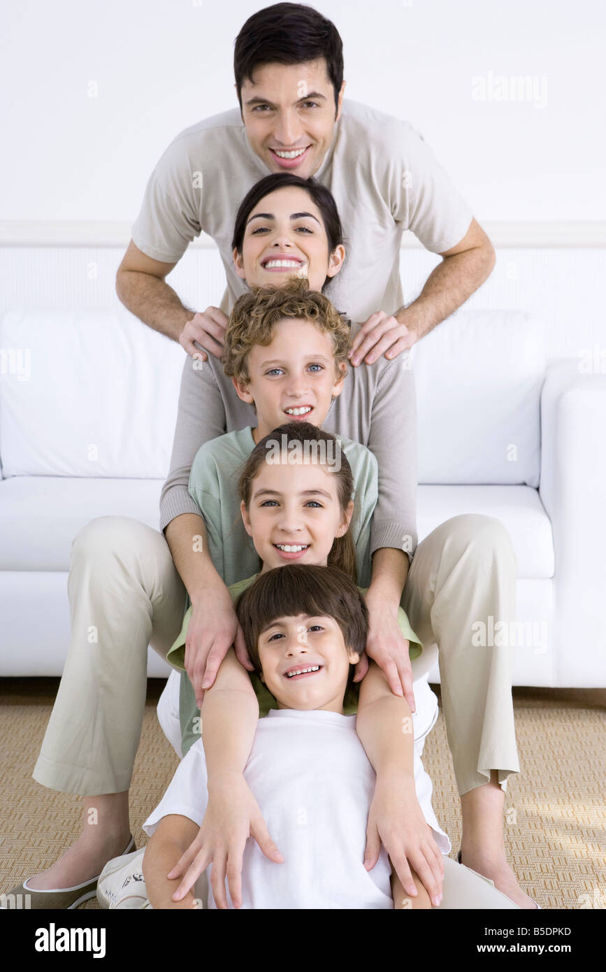 Portrait of family lined up one behind the other, shortest to tallest Stock Photo