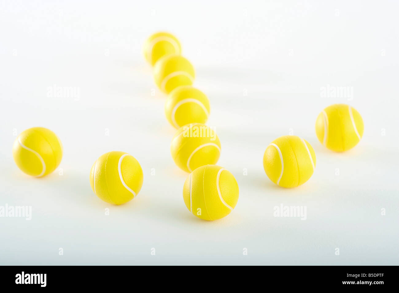Plastic tennis balls arranged in shape of an arrow Stock Photo