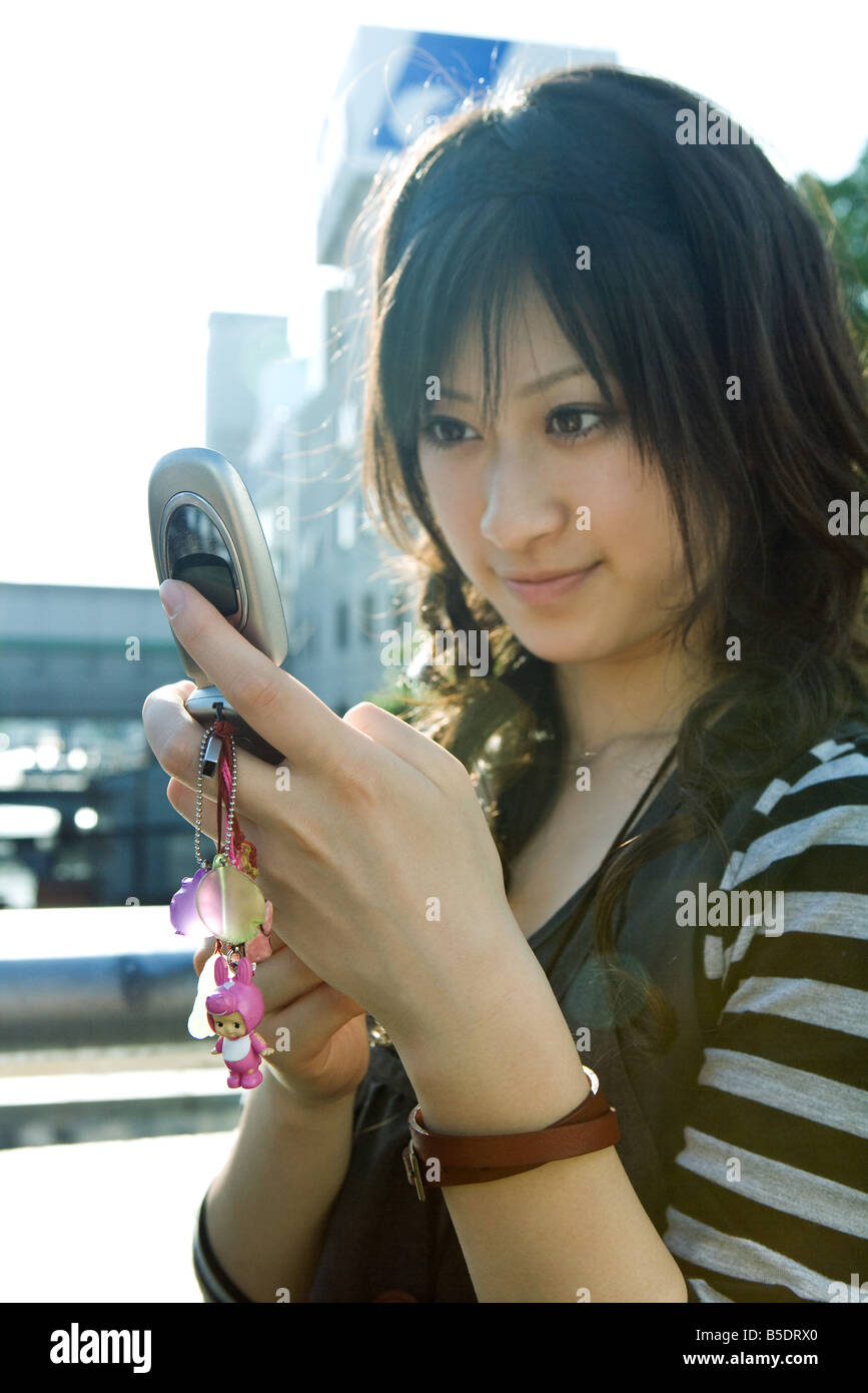 Young Japanese woman looking at cell phone Stock Photo Alamy