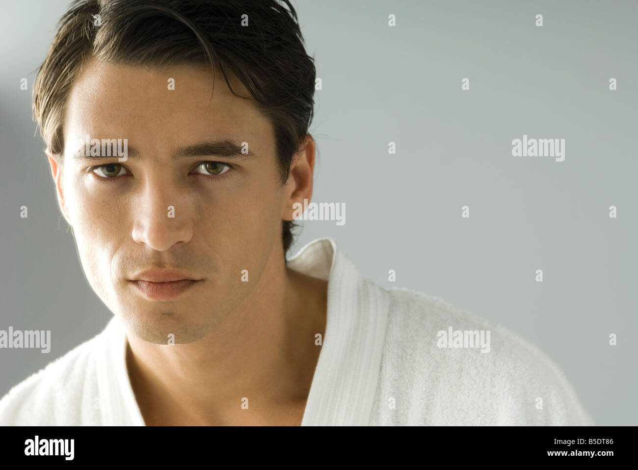 Man in bathrobe looking at camera, portrait Stock Photo