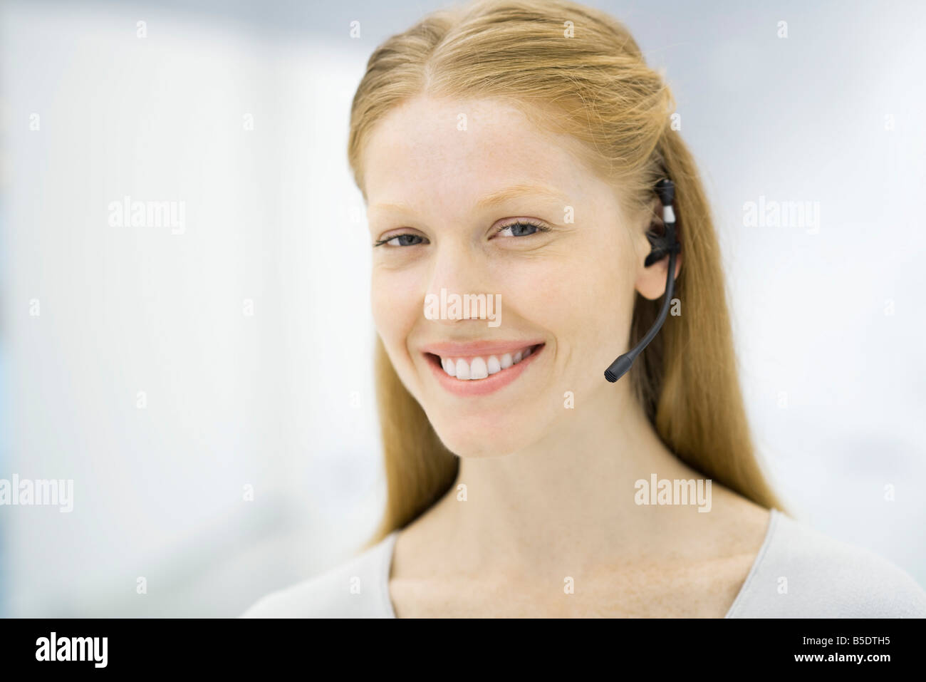 Professional woman wearing headset, smiling, portrait Stock Photo