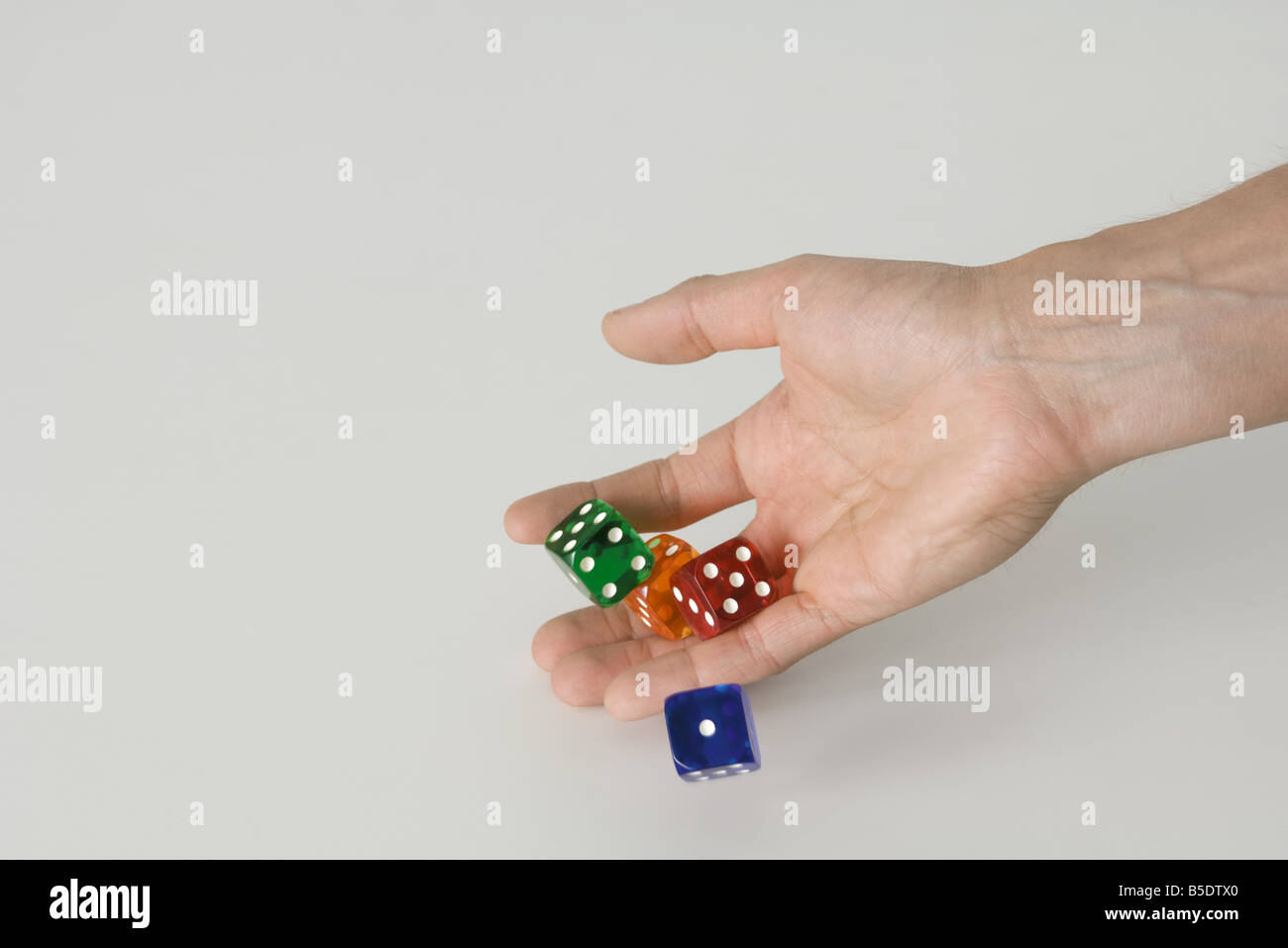 Hand rolling dice Stock Photo Alamy
