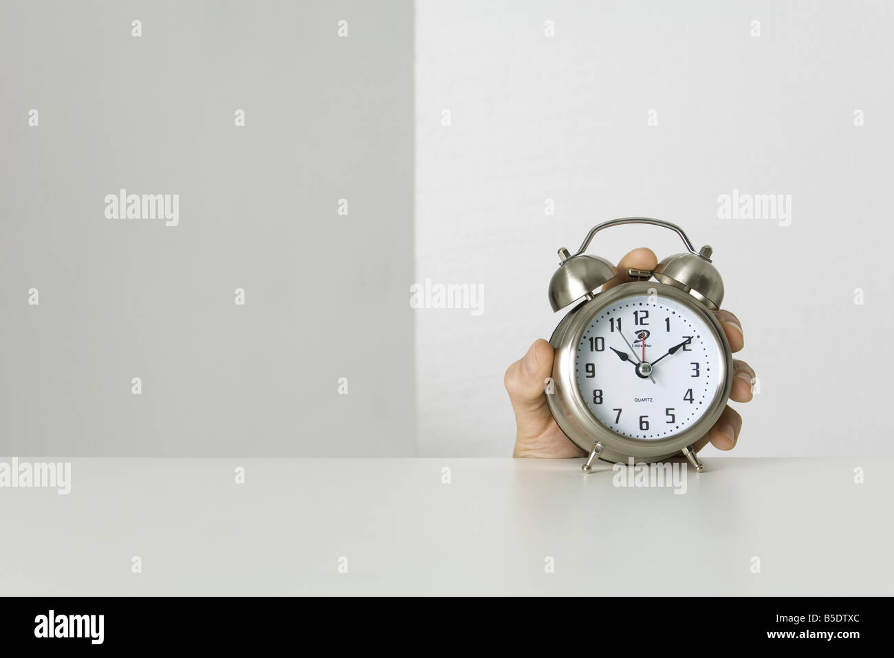 Hand holding alarm clock Stock Photo Alamy