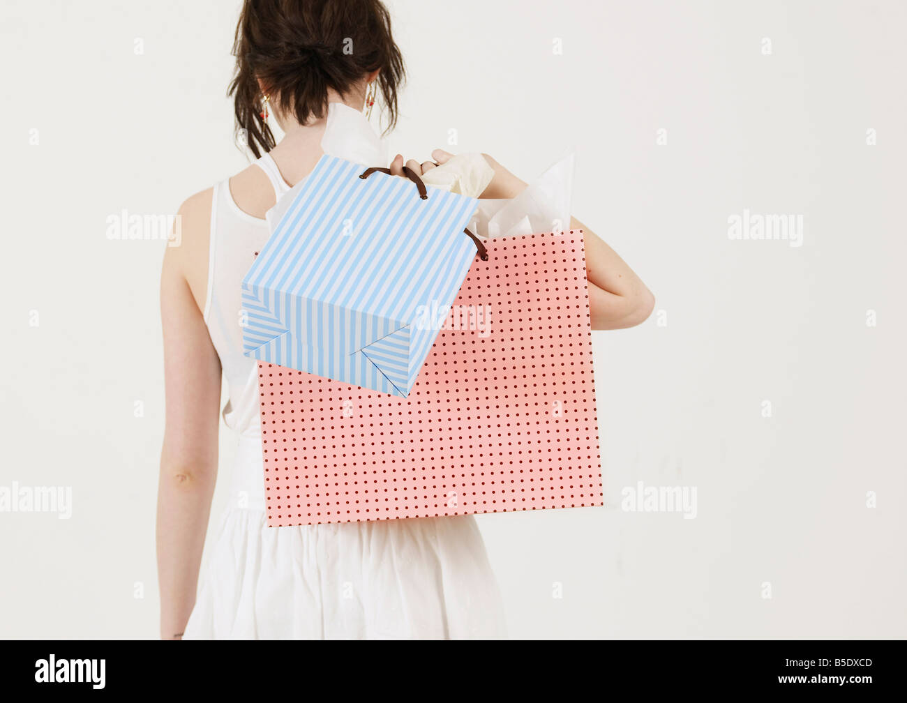 Young Woman Carrying Shopping Bags Stock Photo - Alamy