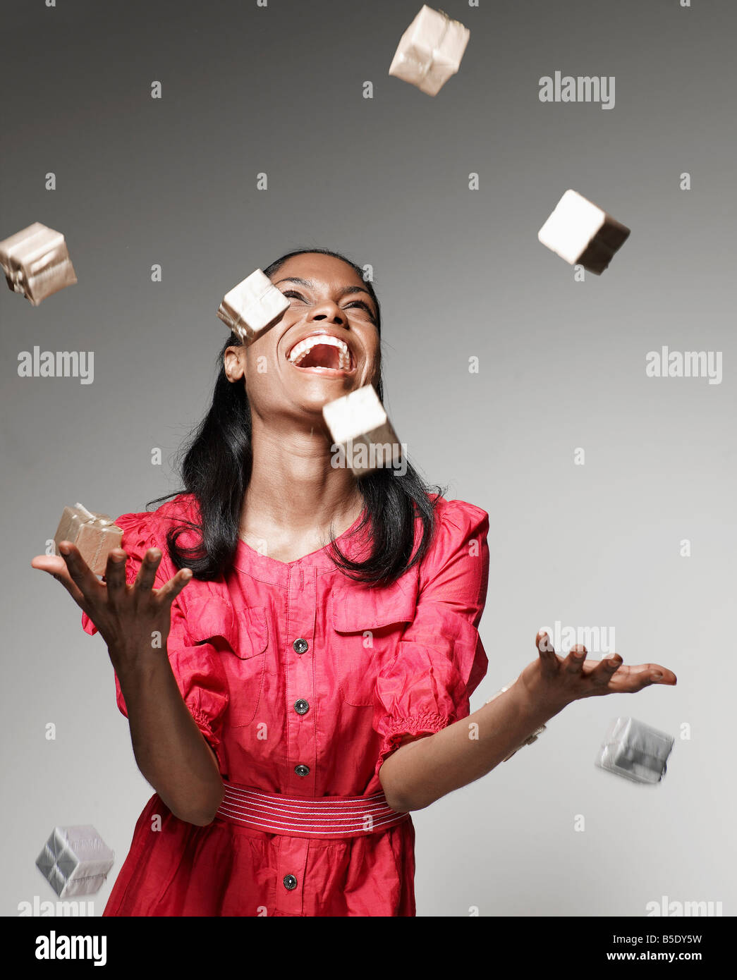 Woman Throwing Small Gifts into Air Stock Photo Alamy
