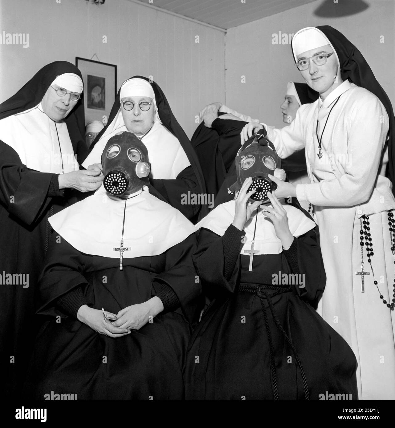 The Nuns at the Convent of Santa Maria Luton, have formed their own civil defence group which is prepared to swing into relief and rescue action in the event of an emergency. The local civil defence and W.V.S. organisations have been instructing them in the use of gas masks. January 1957 Stock Photo