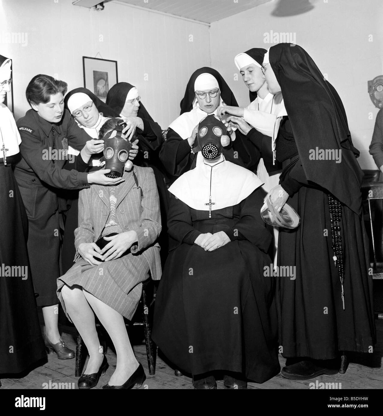 The Nuns at the Convent of Santa Maria Luton, have formed their own civil defence group which is prepared to swing into relief and rescue action in the event of an emergency. The local civil defence and W.V.S. organisations have been instructing them in the use of gas masks. January 1957 Stock Photo