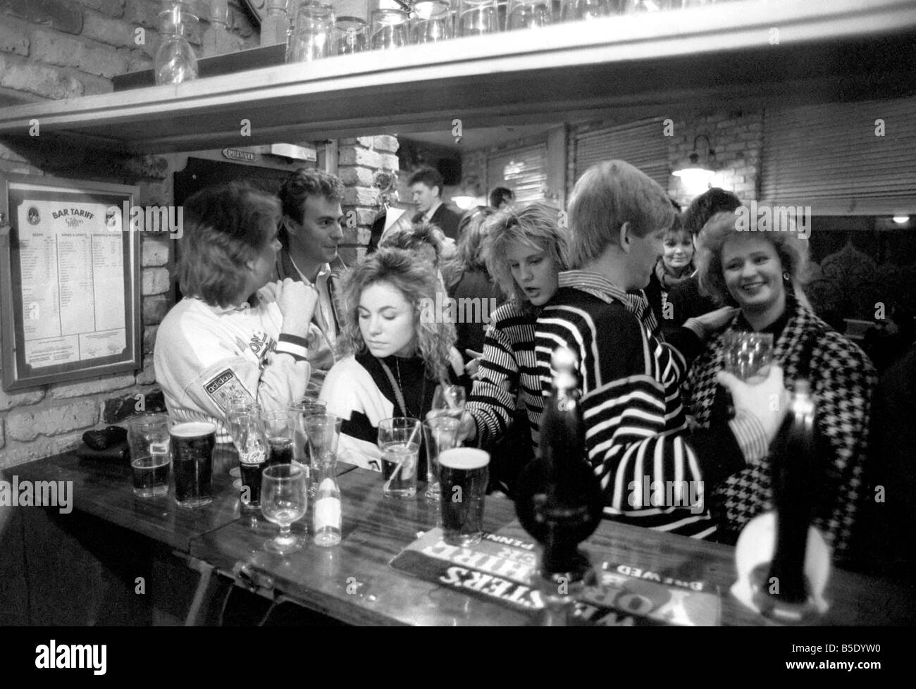 Drinkers in an East End Pub enjoying a pint of beer. March 1987 Stock Photo