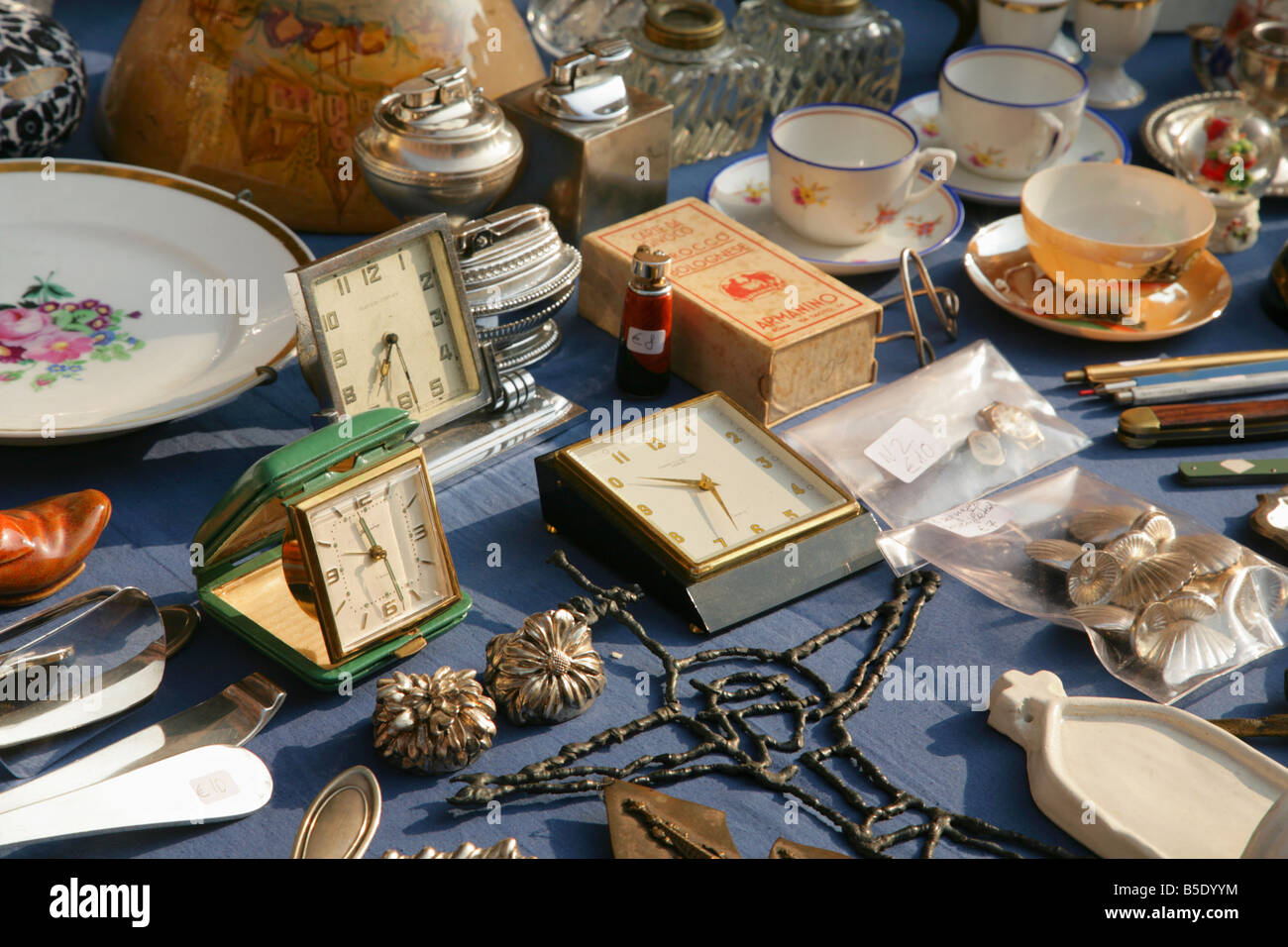 Alarm clocks and miscellaneous items on sale at stall in Bologna Antiques market, Italy. Stock Photo