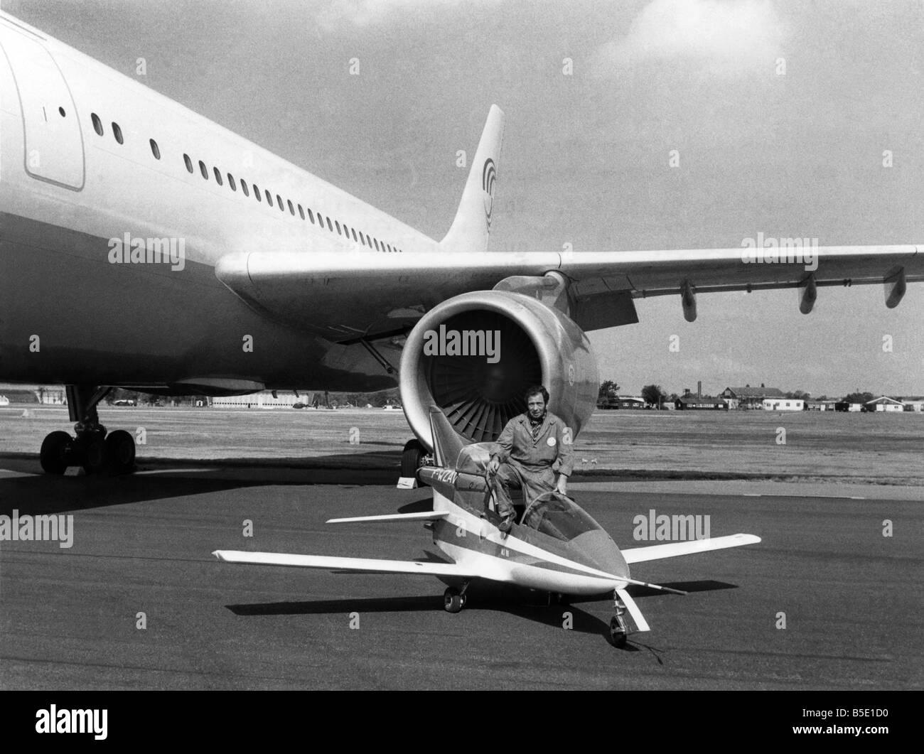 Farnborough 1976: The 1976 Air Show at Farnborough, Hampshire, began on Sunday (5-9-76). The Bede B.D. 5 J.: This is the smallest jet plane in the world measuring 12.4 feet long. It was built in France and is only 5 foot 11 inches high, which is quite obvious as it is dwarfed by a single engine of a European Air bus. September 1976 P001074 Stock Photo