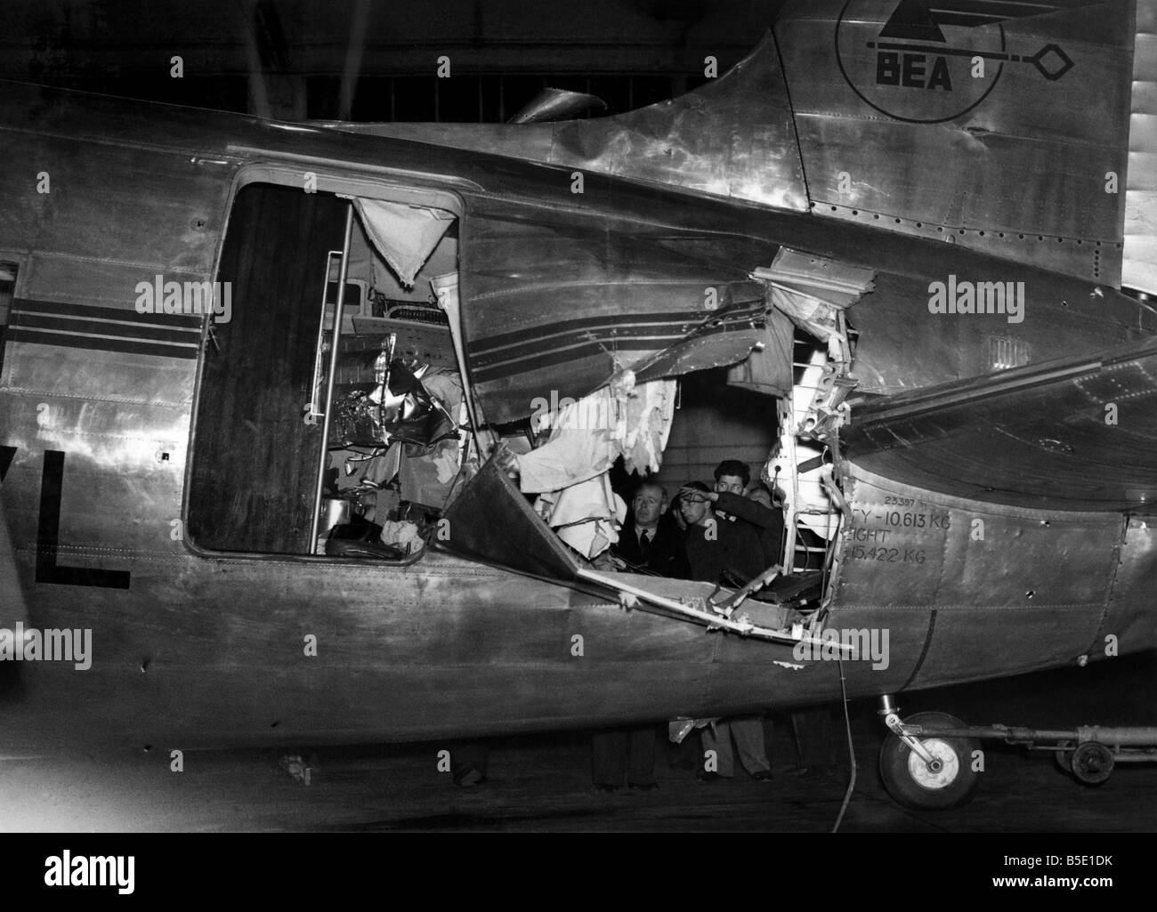 Pilot Flies Home Airliner Torn open by Lightning: A B.E.A. airliner with gaping holes in its fuselage, its main door almost wrenched off, and its tail rudder out of action was successfully bellylanded at Northolt Airport by the pilot, Captain I.R. Harvey. The plane, a Vickers Viking, was struck by lightning during a freak storm over the Channel while flying to Paris. Stewardess Sue Cramsie, in the tail of the plane, received a broken arm and other injuries. But none of the twenty-seven passengers or the other three members of the crew was hurt. April 1950 P001090 Stock Photo