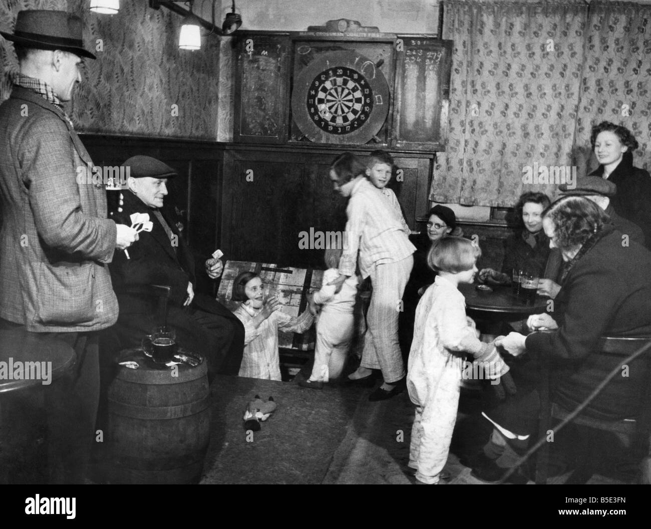 Children pass through the bar of the ThatcherÛs Inn at Brentwood, Essex, on their way to their shelter bed in the cellar. They a Stock Photo