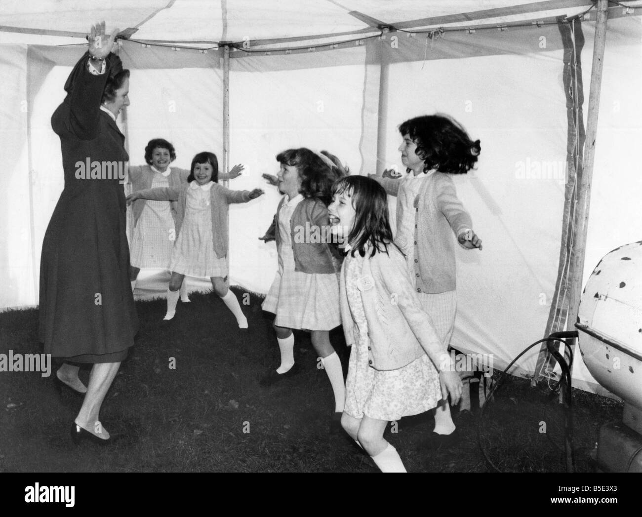 Prime Minister Margaret Thatcher seen here leading a group of children in a session of physical exercise designed to beat the winter chill at Winifred School, Stockport. December 1981 P003361 Stock Photo