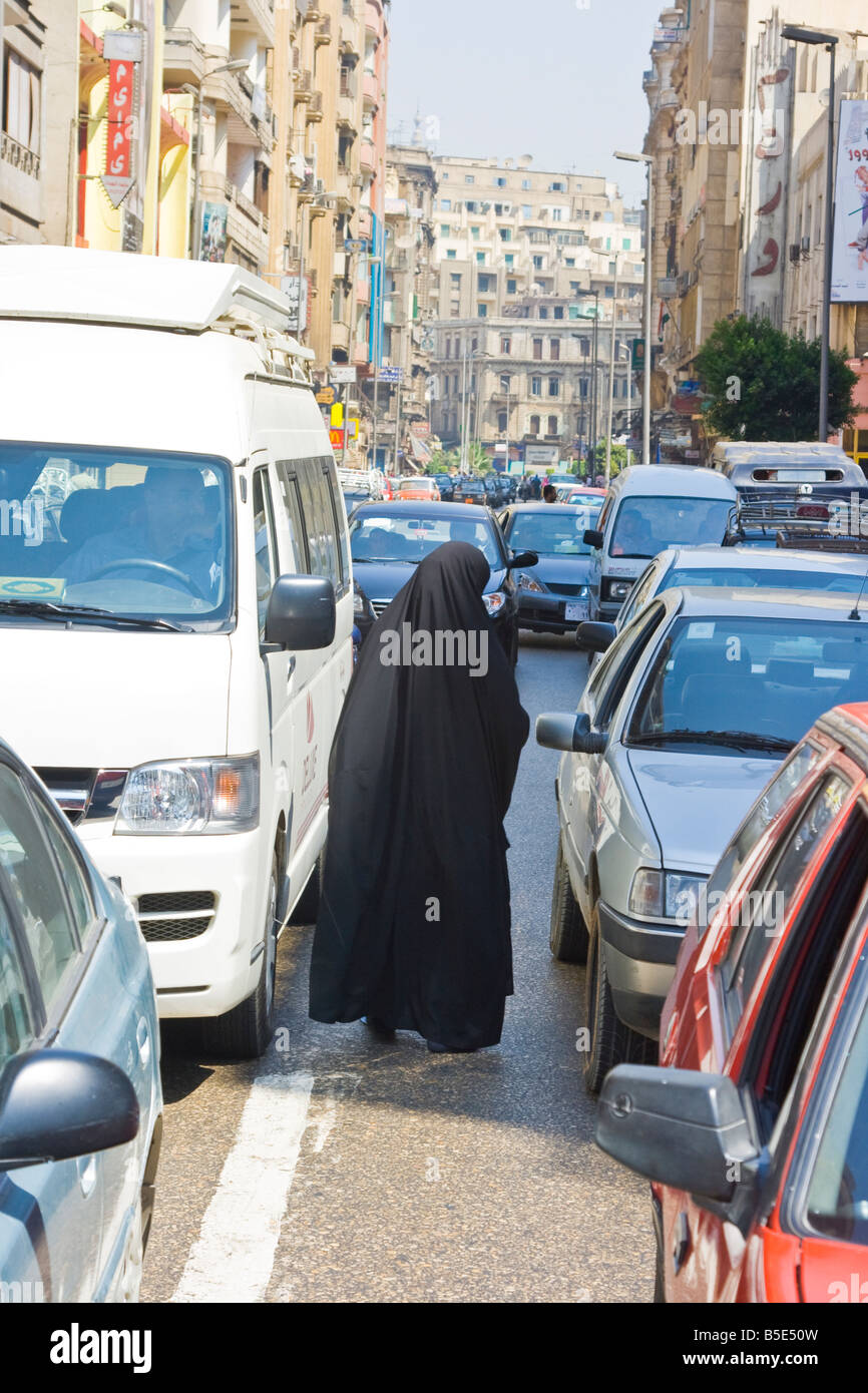 Poor Muslim Woman Begging from Cars in Cairo Egypt Stock Photo